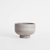 Handmade gray ice cream bowl against a white background.