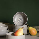 Close-up of the interior of a single handmade ceramic bowl in earthy, natural tones.
